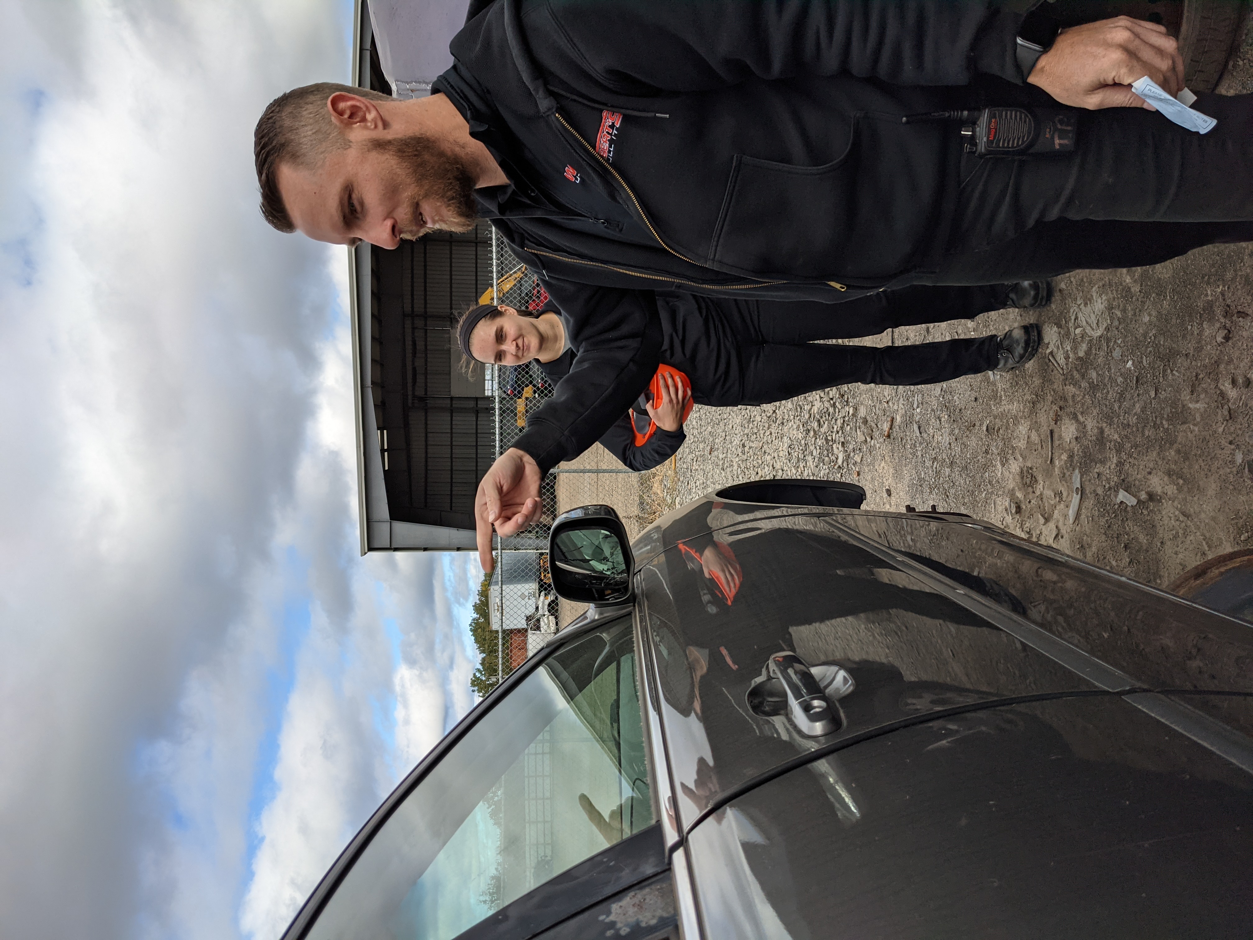 Tyler Petrie and Dakota Morrison next to a Toyota Camry in the Wilbert's U-Pull It yard in Williamson NY 