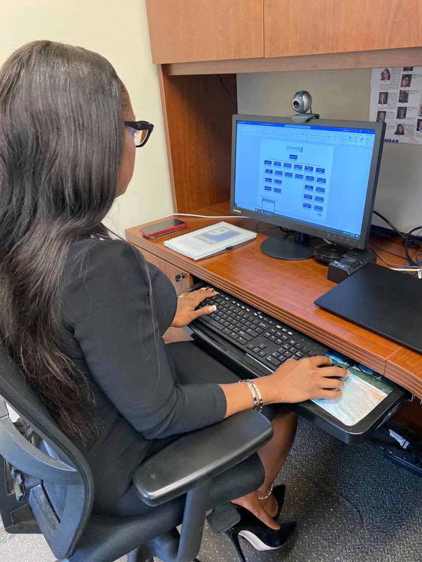 Jennifer Boutte working at her desk at Goodwill of the Finger Lakes in Rochester NY