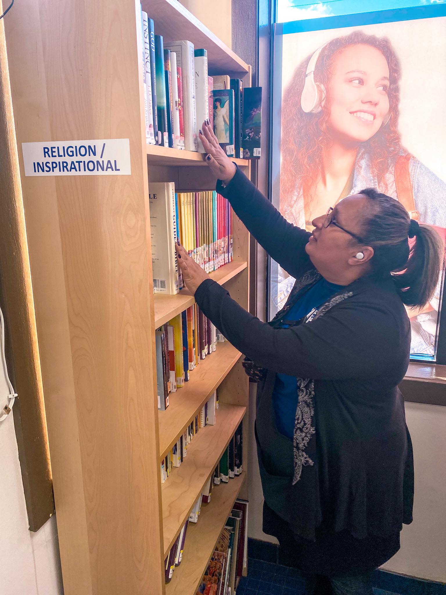 Amy Crespo working at Goodwill Bookstore in Webster NY