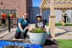 Two women planting flowers