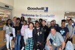 group of students posing beside a Goodwill sign