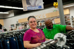 Goodwill store customers shopping for discount clothing