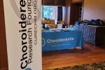Picture of the CRF banner and the Welcome/Registration table for the conference